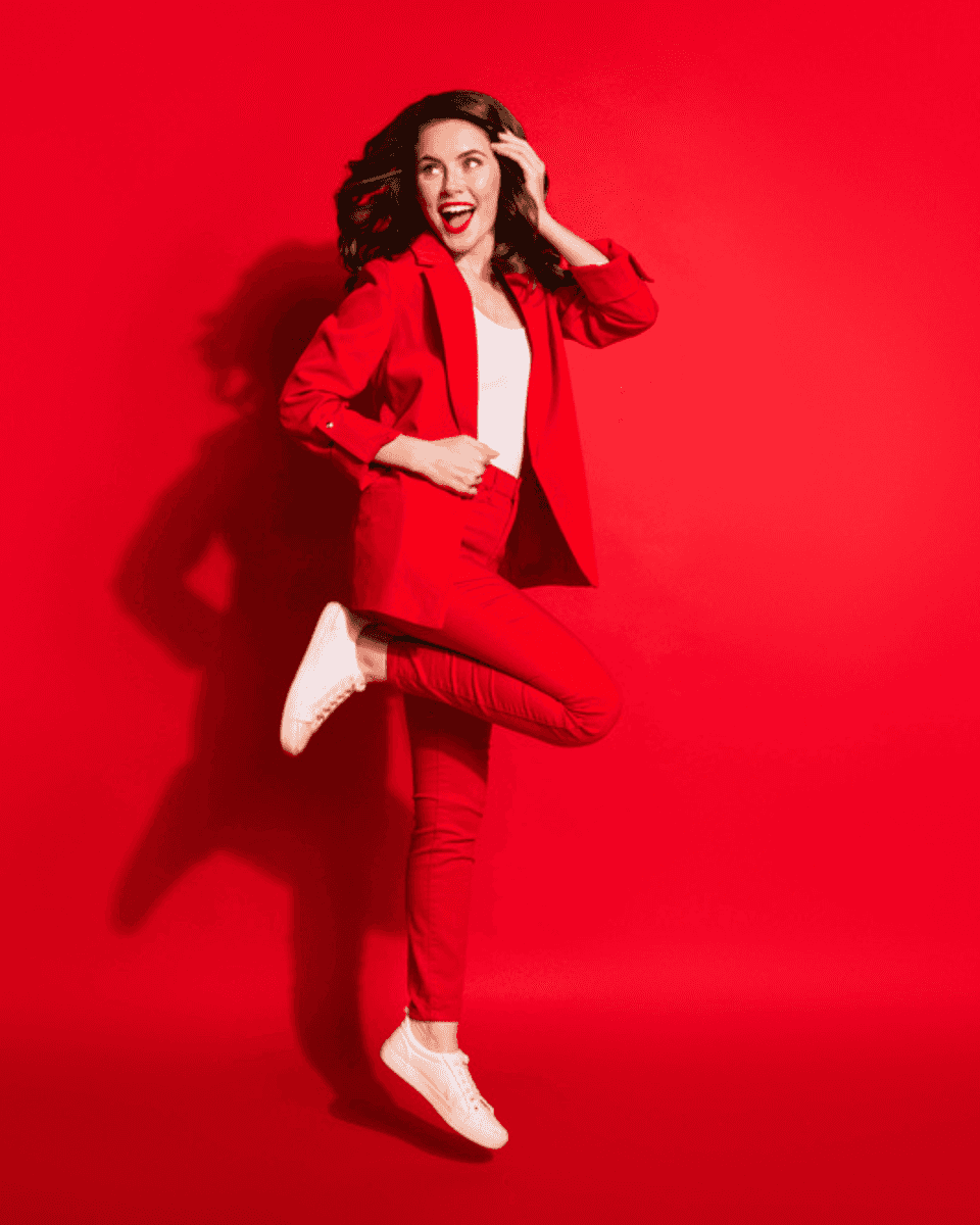 Woman in a red suit jumping